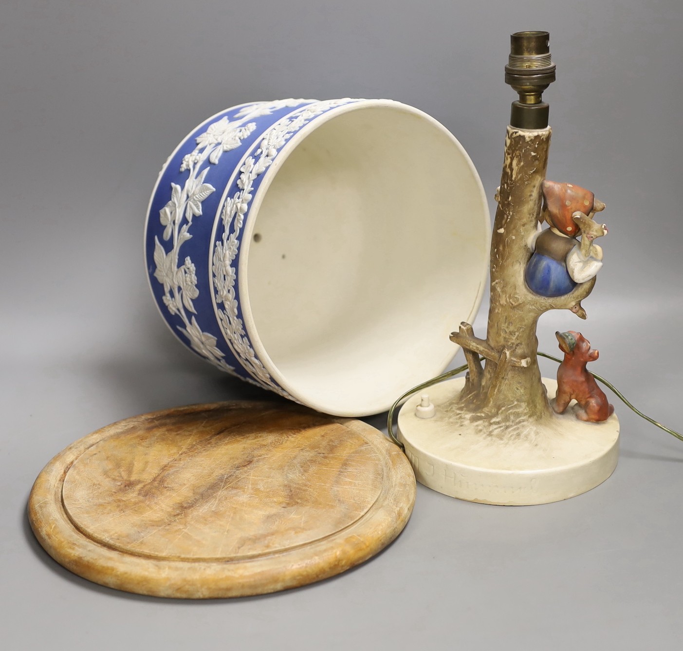 A Victorian blue jasper cheese bell cover, later wood stand, 23 cm high, and a Hummel table lamp